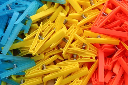clothes pegs in three colors as very nice background