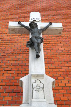 crucifix religion symbol on the old  brick wall