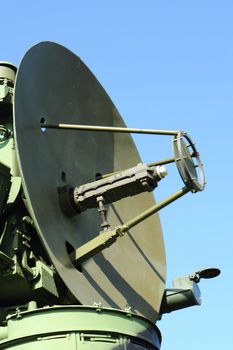 army radar against blue sky as old war background