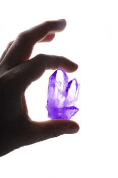 crystal in the hand isolated on the white background