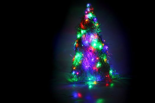 christmas tree form the color xmas lights as holiday background