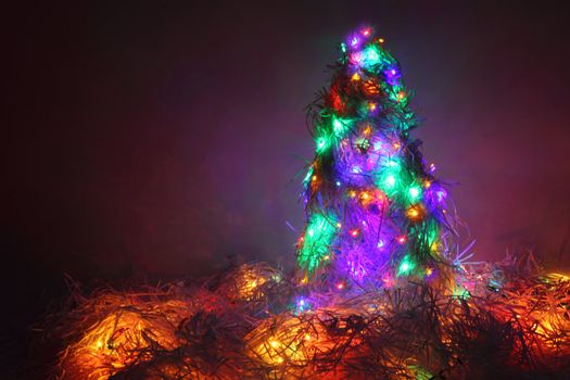 christmas tree form the color xmas lights as holiday background