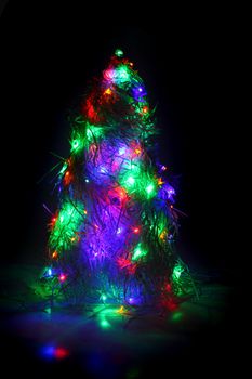 christmas tree form the color xmas lights as holiday background