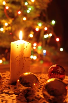 christmas candle with xmas tree in the background