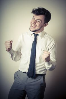 happy successful stylish businessman on gray background