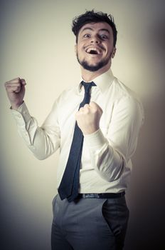 happy successful stylish businessman on gray background