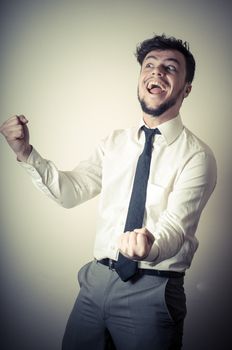 happy successful stylish businessman on gray background