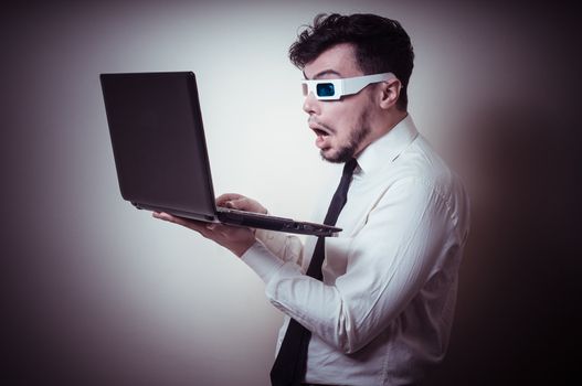businessman with 3d eyewear watching laptop on gray background