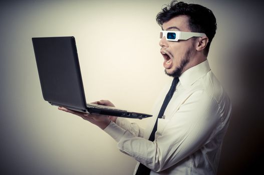 businessman with 3d eyewear watching laptop on gray background