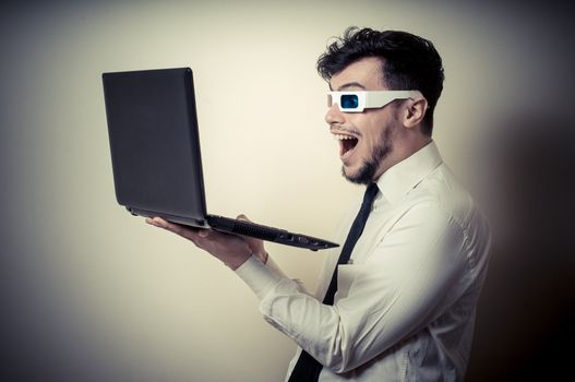 businessman with 3d eyewear watching laptop on gray background