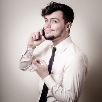 stylish business man on the phone on gray background