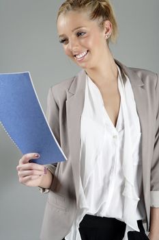 Young beautiful woman in a business suit reading documents.