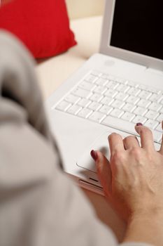 Womans hands typing on laptop keyboard