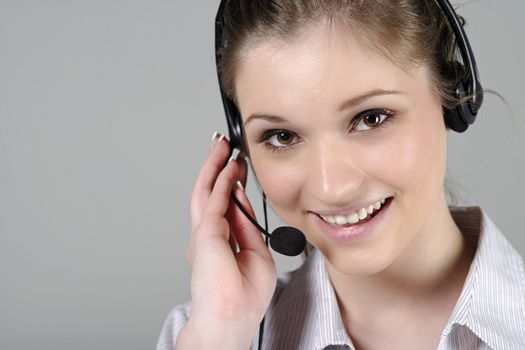 Young woman wearing a telephone headset talking on the phone