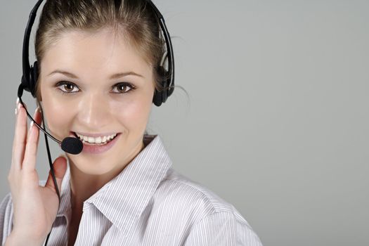 Young woman wearing a telephone headset talking on the phone