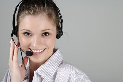 Young woman wearing a telephone headset talking on the phone