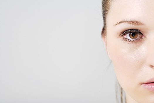 Young woman in a beauty style pose with half of her face off camera