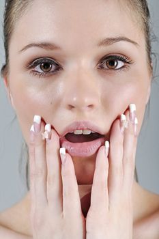 Young woman in a beauty style pose with her hands round her face