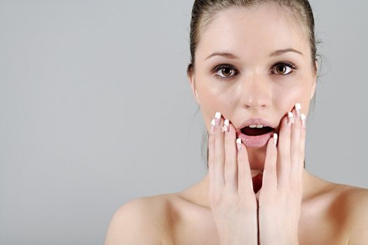 Young woman in a beauty style pose with her hands round her face