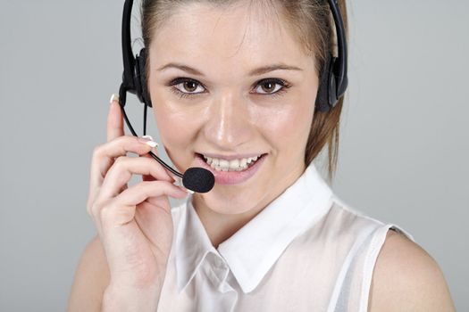 Young woman wearing a telephone headset talking on the phone