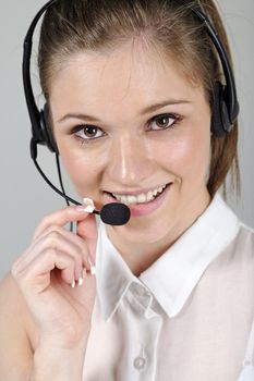 Young woman wearing a telephone headset talking on the phone