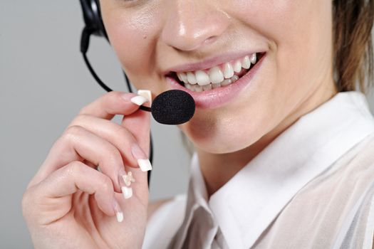 Young woman wearing a telephone headset talking on the phone