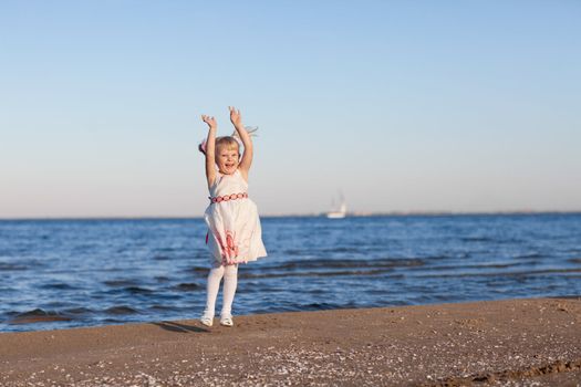 small jumping girl on the beach