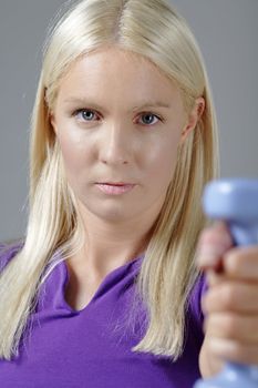 Young woman holding weights and working out