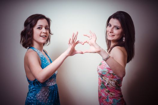 two beautiful girls on gray background