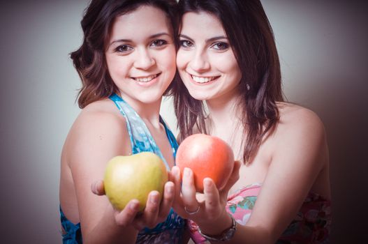 two beautiful girls on gray background