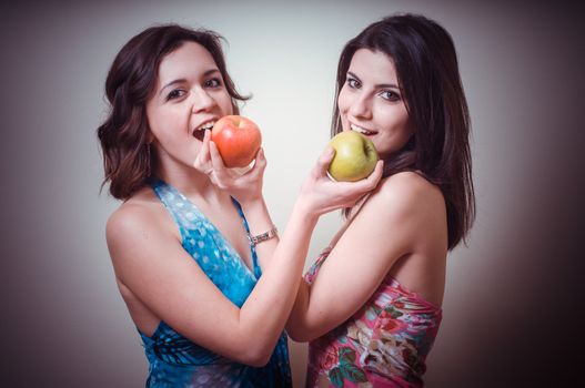 two beautiful girls on gray background