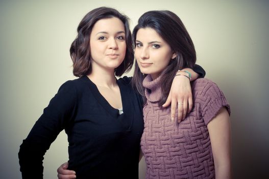 two beautiful girls on gray background