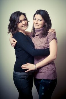 two beautiful girls on gray background