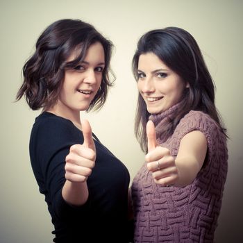 two beautiful girls on gray background