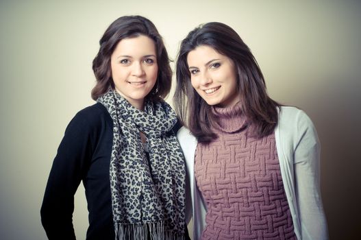 two beautiful girls on gray background