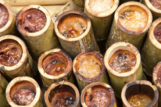 Glutinous rice roasted in bamboo joints., sticky rice in bamboo tube