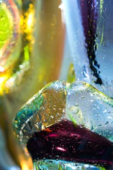 Bright colorful abstract background. Glass and drops of water. Closeup.