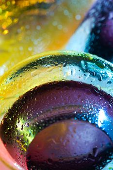 Bright colorful abstract background. Glass and drops of water. Closeup.