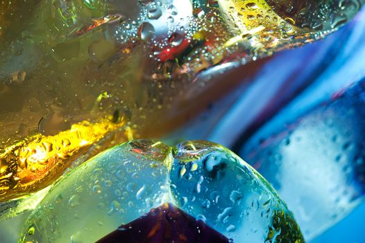 Bright colorful abstract background. Glass and drops of water. Closeup.