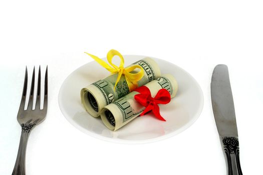 Rolls dollars with  bow for a plate. Isolated on a white background.