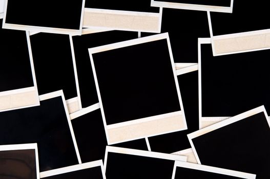 Image of a random assortment/layout of a handful of empty instant prints. 