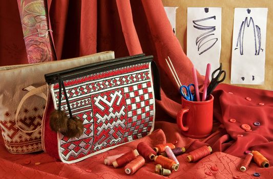 fashion sketches, handbags, red fabric, buttons and thread