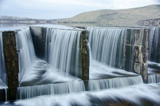 Water flowing from dam. lake.