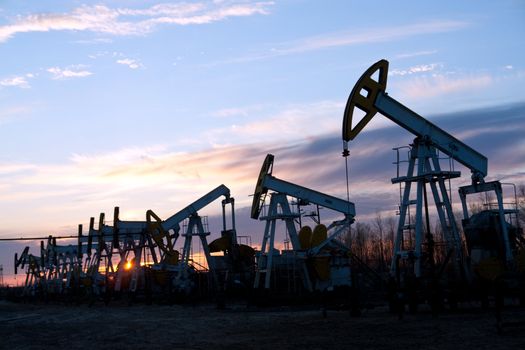 oil pumps at sunset sky  background 