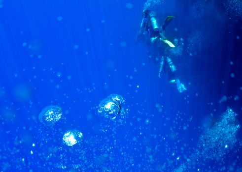 Underwater abstract background with bubbles and divers