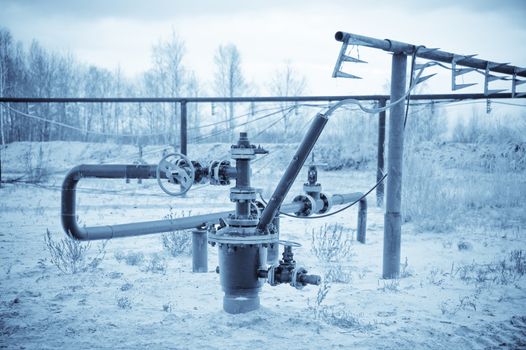 Oil, gas industry. Wellhead with valve armature. Toned.