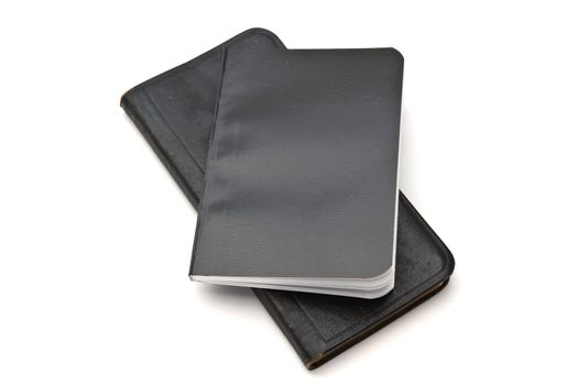 Black notebooks closeup on white background