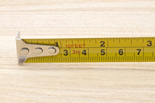 Tape measure closeup on wood background 