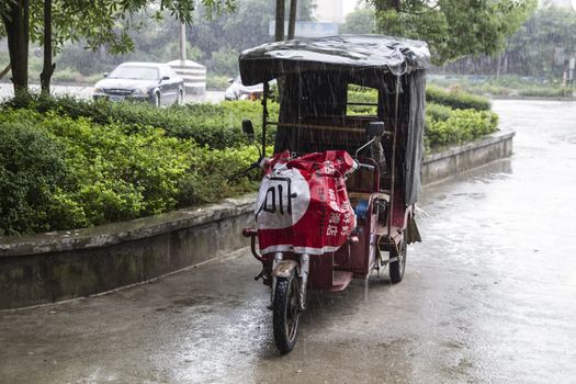 Electric pedicab taxi in the rain