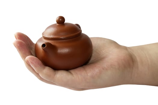 Chinese teapot in hand closeup on white background